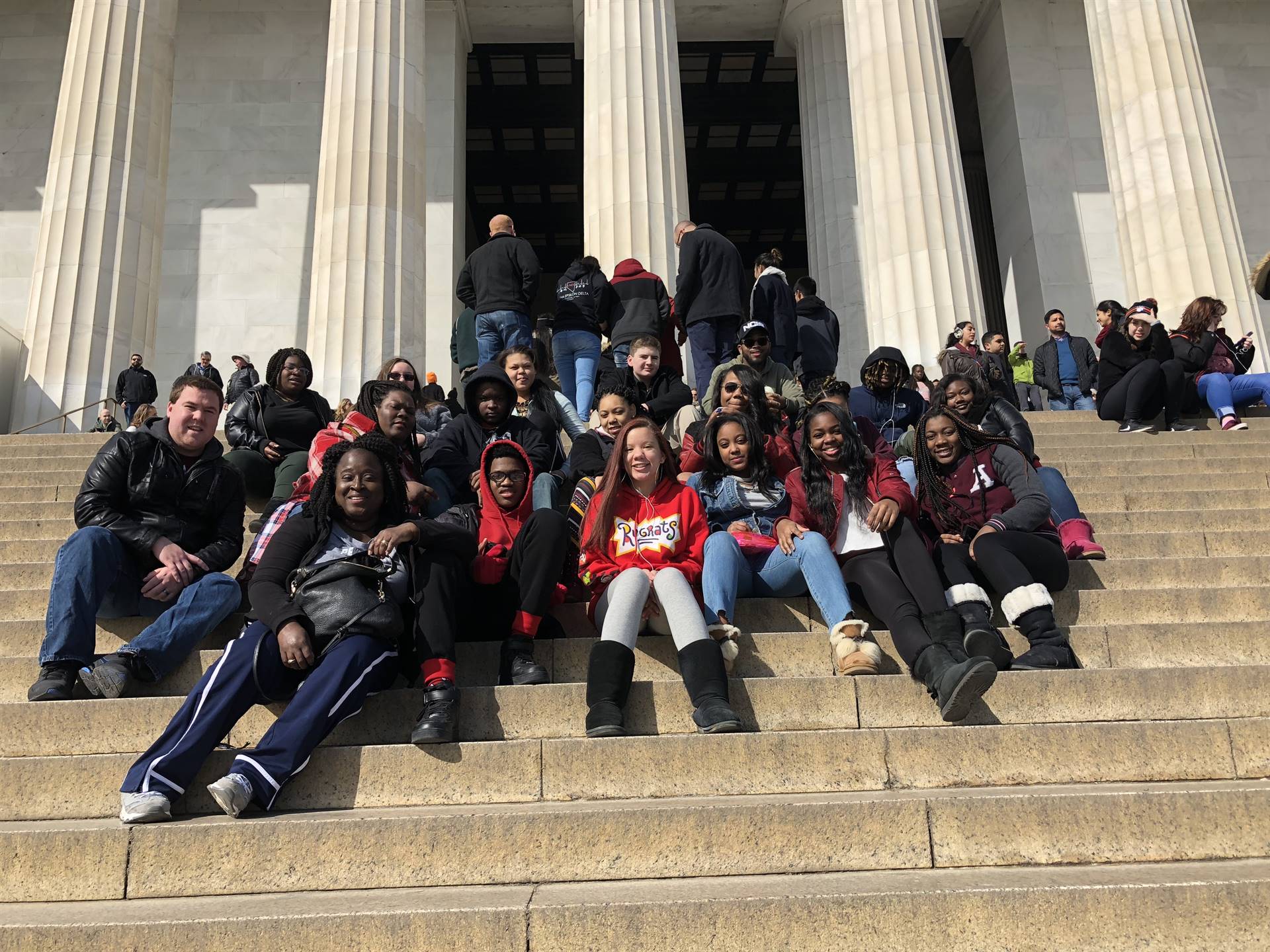 Students on the steps of a memorial