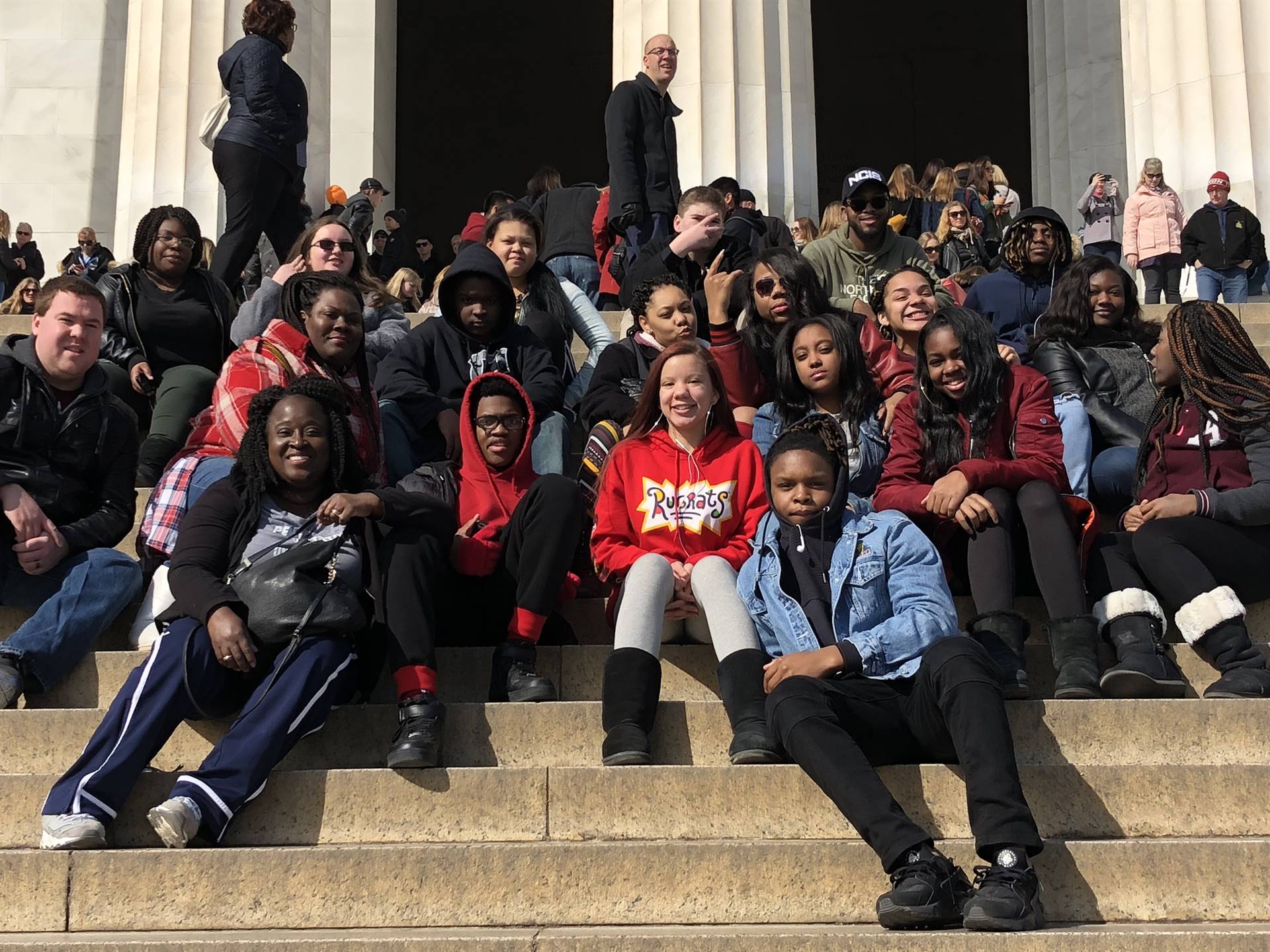 Students on the steps of a memorial (2)