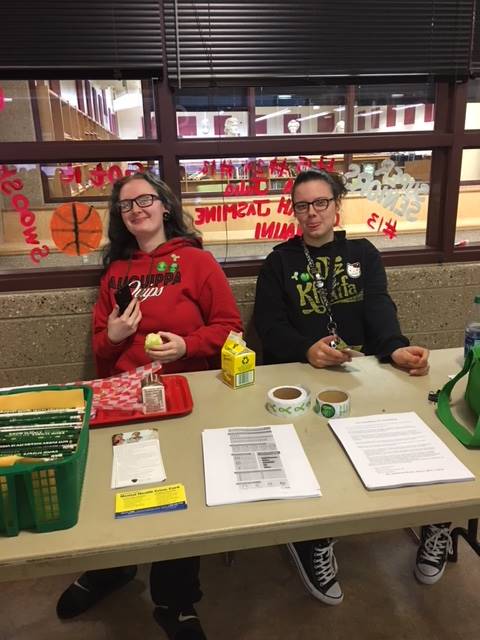 Students behind table